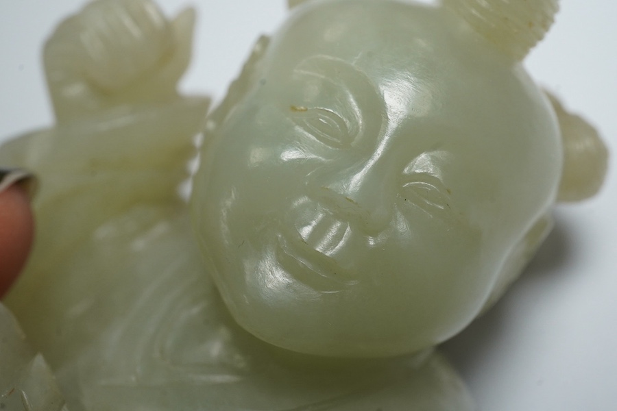 A Chinese pale celadon jade figure of a boy, 18th century